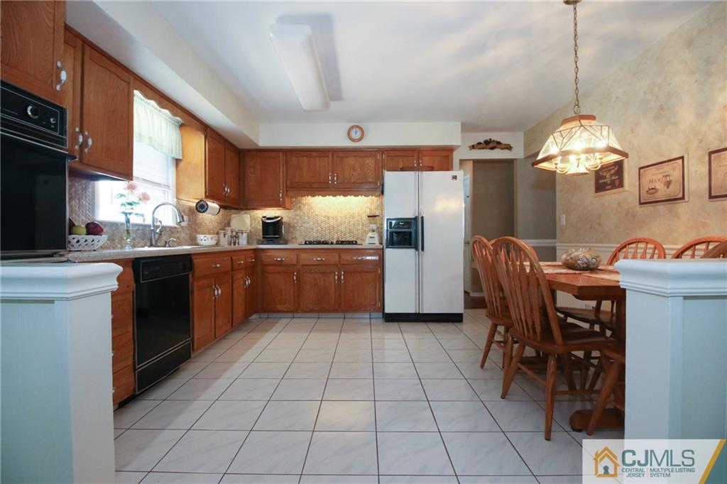 20 Corey Drive Ewing, NJ 08618 - Photo 9 of 25 a kitchen with stainless steel appliances granite countertop a sink counter space and a view of living room