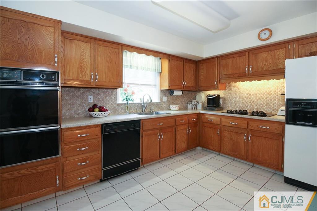 20 Corey Drive Ewing, NJ 08618 - Photo 10 of 25 a kitchen with stainless steel appliances granite countertop a refrigerator sink and cabinets