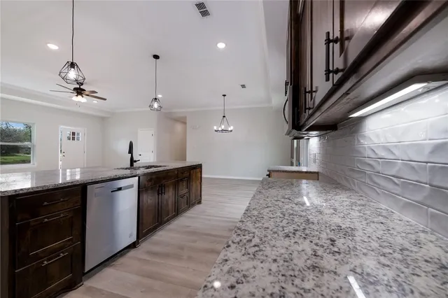 a large kitchen with kitchen island a sink stainless steel appliances and cabinets