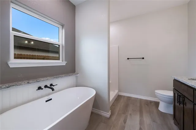 a bathroom with a bathtub and a toilet