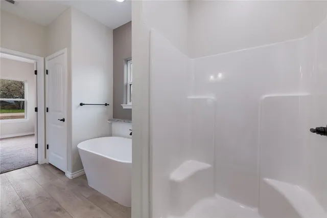 a bathroom with a bathtub and shower