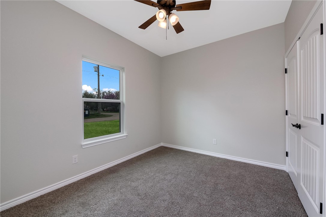 402 F Street Meridian, TX 76665 - Photo 29 of 32 wooden floor in an empty room with a window