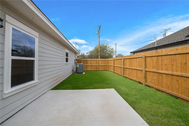 a view of a backyard with grass and entertaining space