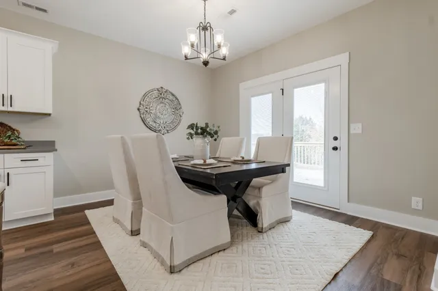 a dining room with table and chairs