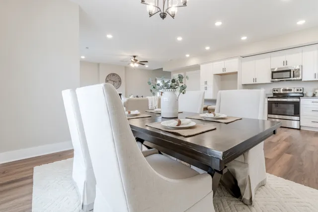 a kitchen with stainless steel appliances a stove a sink a refrigerator and cabinets