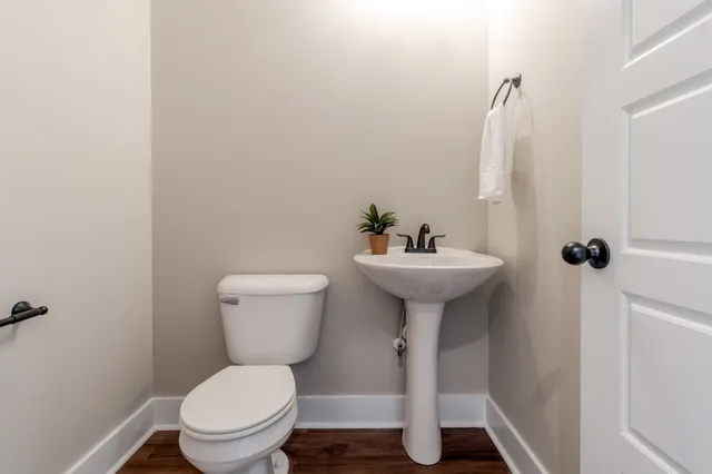 a bathroom with a sink toilet and a mirror
