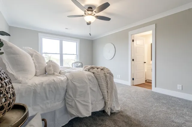 a spacious bedroom with a bed and window