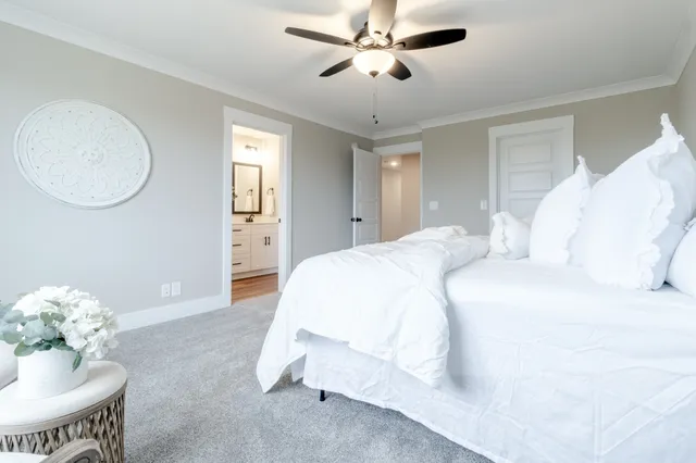 a spacious bedroom with a bed and chandelier
