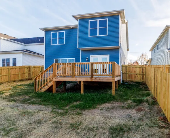 a front view of a house with garden and deck