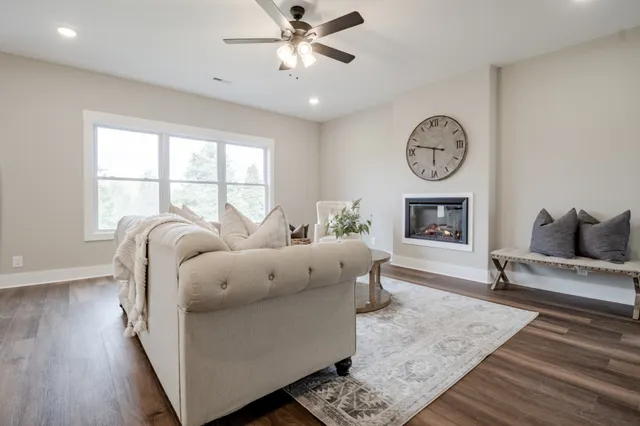 a living room with furniture fireplace and window