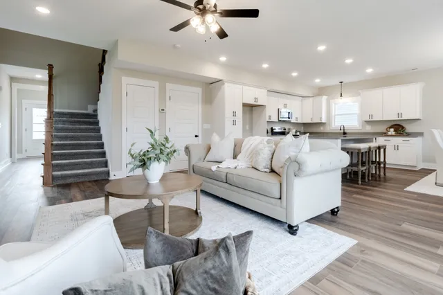 a living room with furniture kitchen view and a table