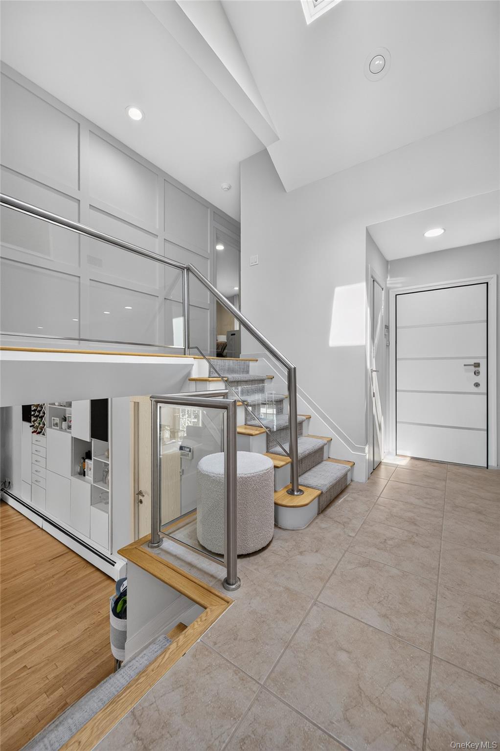 11 Sunbeam Road Syosset, NY 11791 - Photo 6 of 28 View of European front door, staircase, glass-panel railings and accent wall