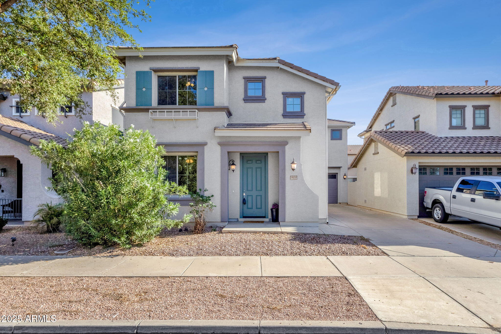 front view of a house with a pathway and a yard