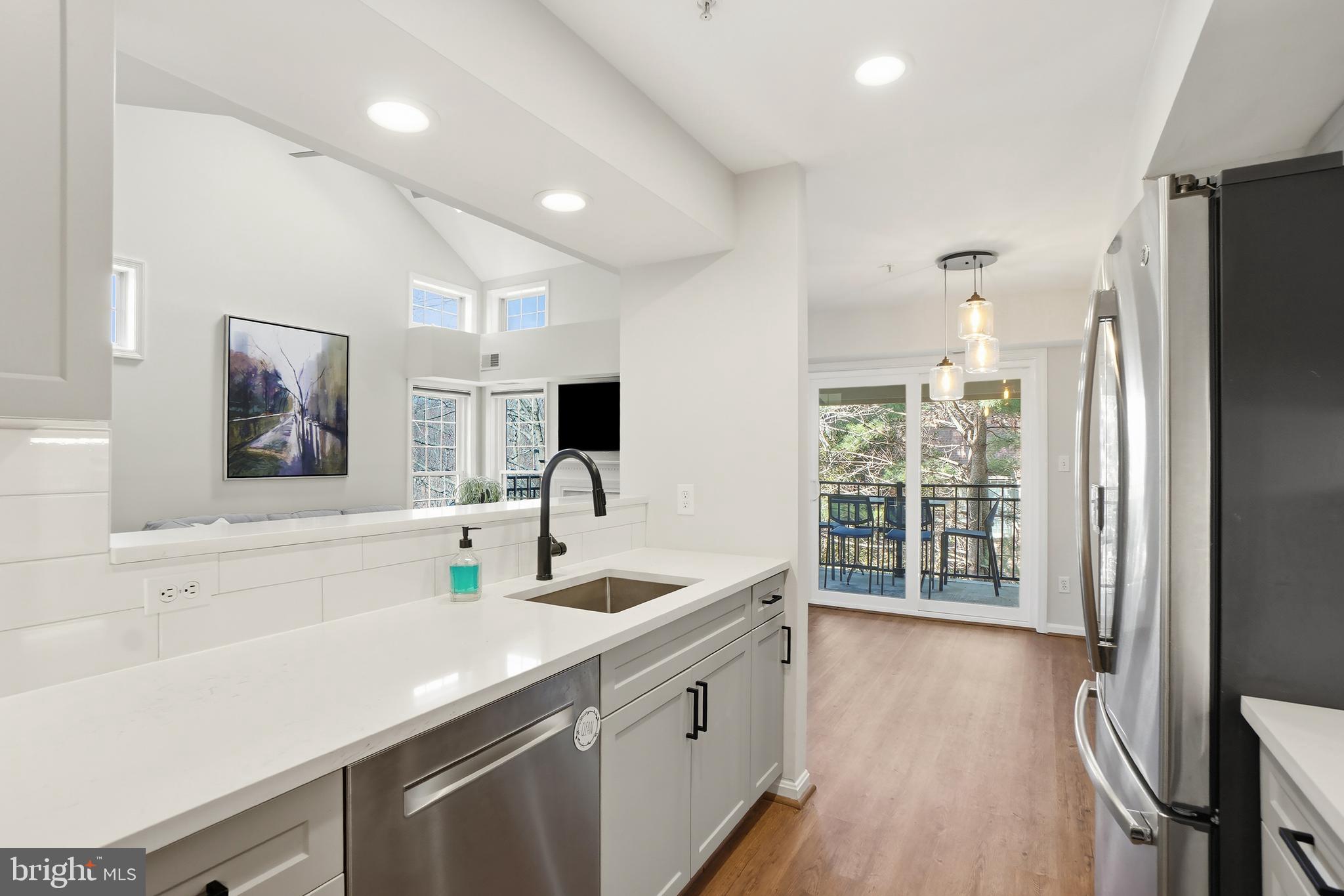 1365 Garden Wall Circle, Unit 703 Reston, VA 20194 - Photo 13 of 31 Bar counter means guests will hang while you cook