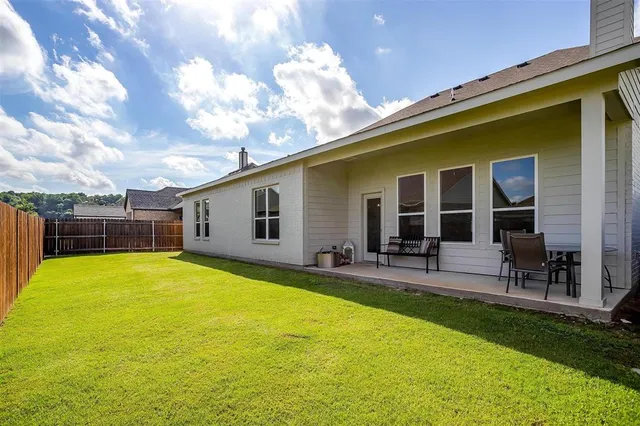 a view of a house with swimming pool and sitting area