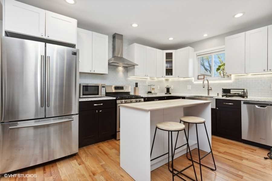 263 Fishkill Avenue Beacon, NY 12508 - Photo 9 of 36 a kitchen with stainless steel appliances granite countertop a refrigerator a sink dishwasher a stove and white cabinets with wooden floor