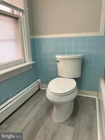a bathroom with a toilet sink and window