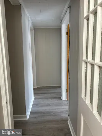 a view of an entryway with wooden floor