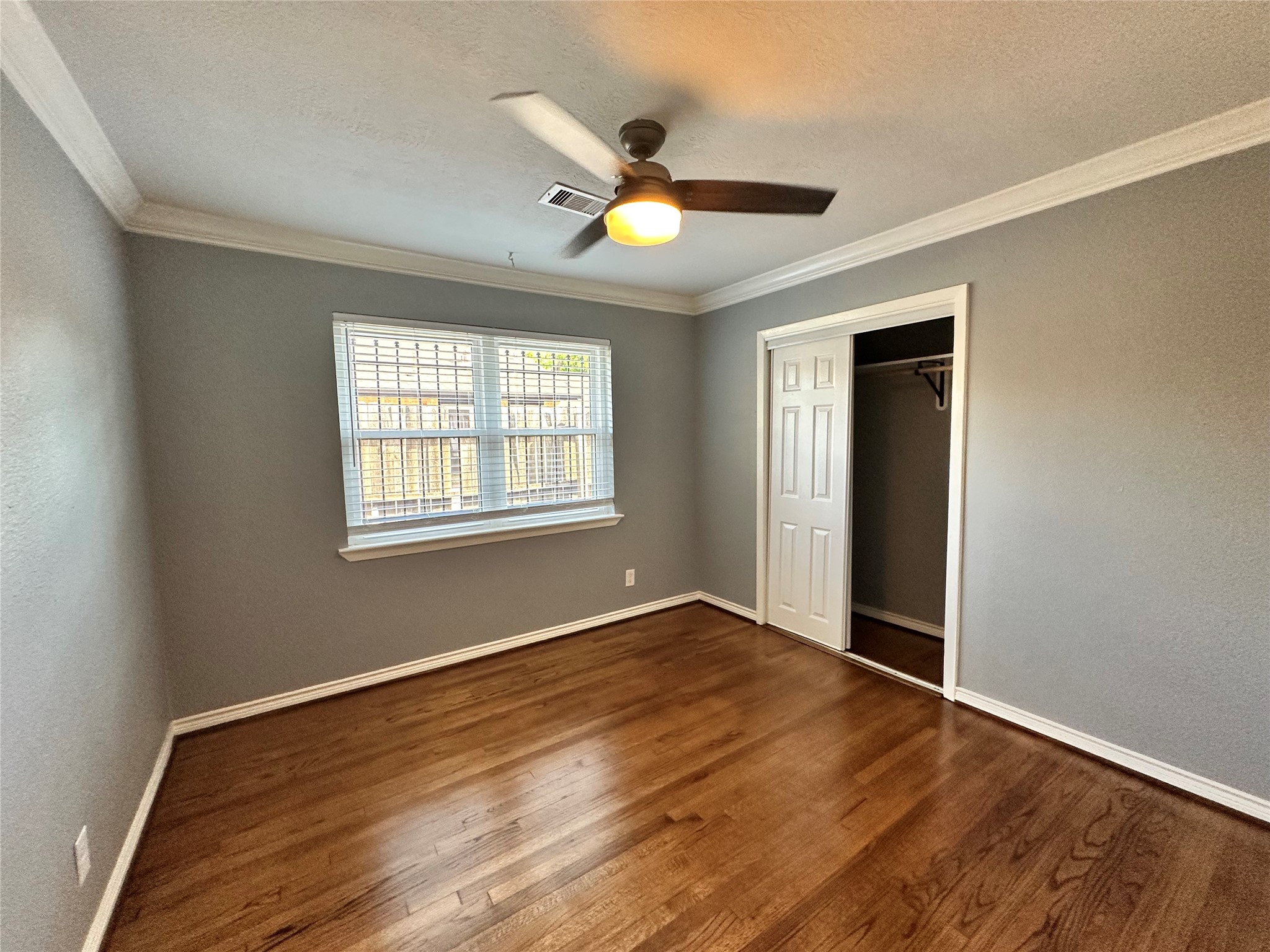 2206 South Houston Road Pasadena, TX 77502 - Photo 9 of 11 a view of an empty room with wooden floor and a window