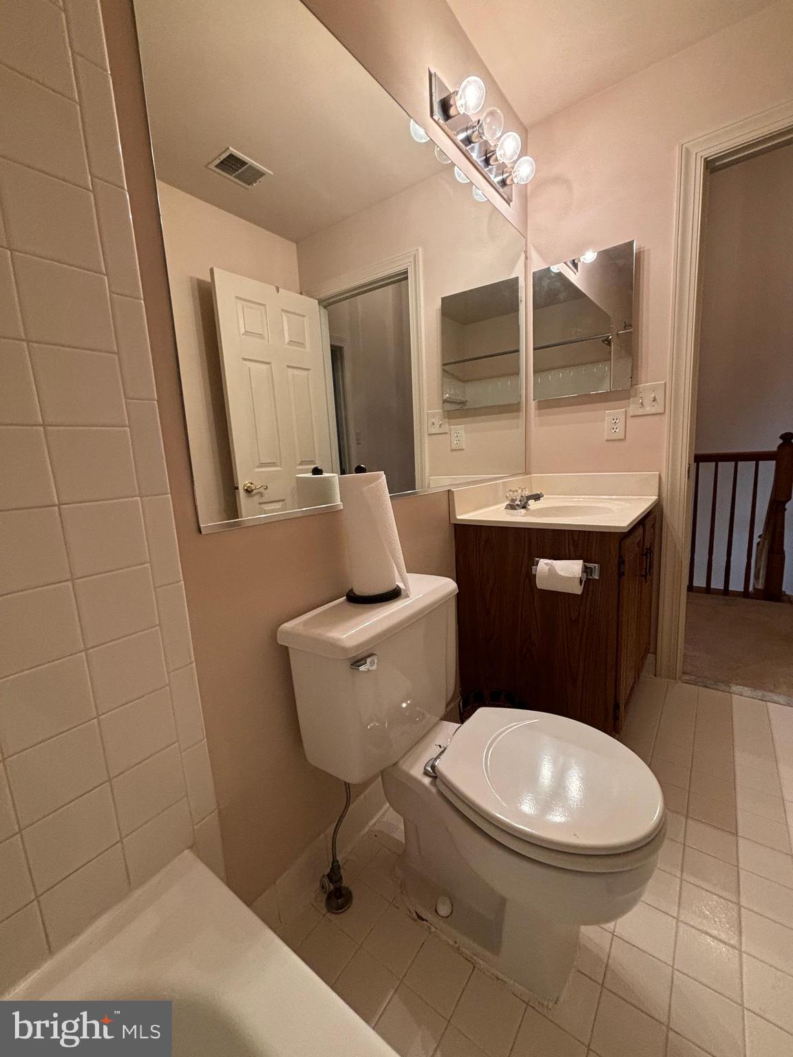 11223 Watermill Lane Silver Spring, MD 20902 - Photo 19 of 39 a bathroom with a toilet sink and mirror