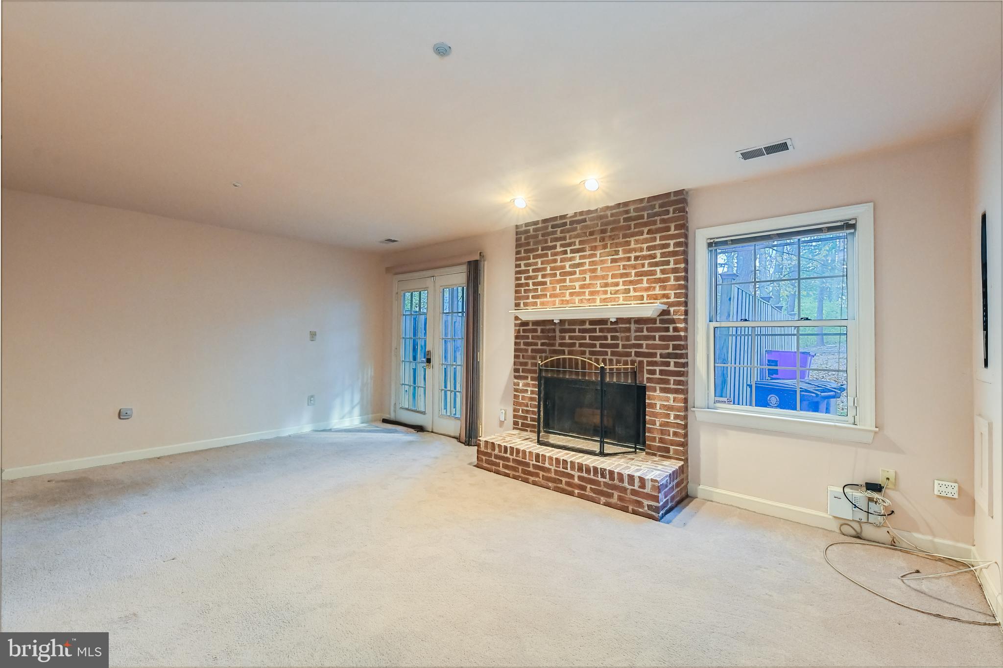 11223 Watermill Lane Silver Spring, MD 20902 - Photo 27 of 39 a view of an empty room with a fireplace and a window