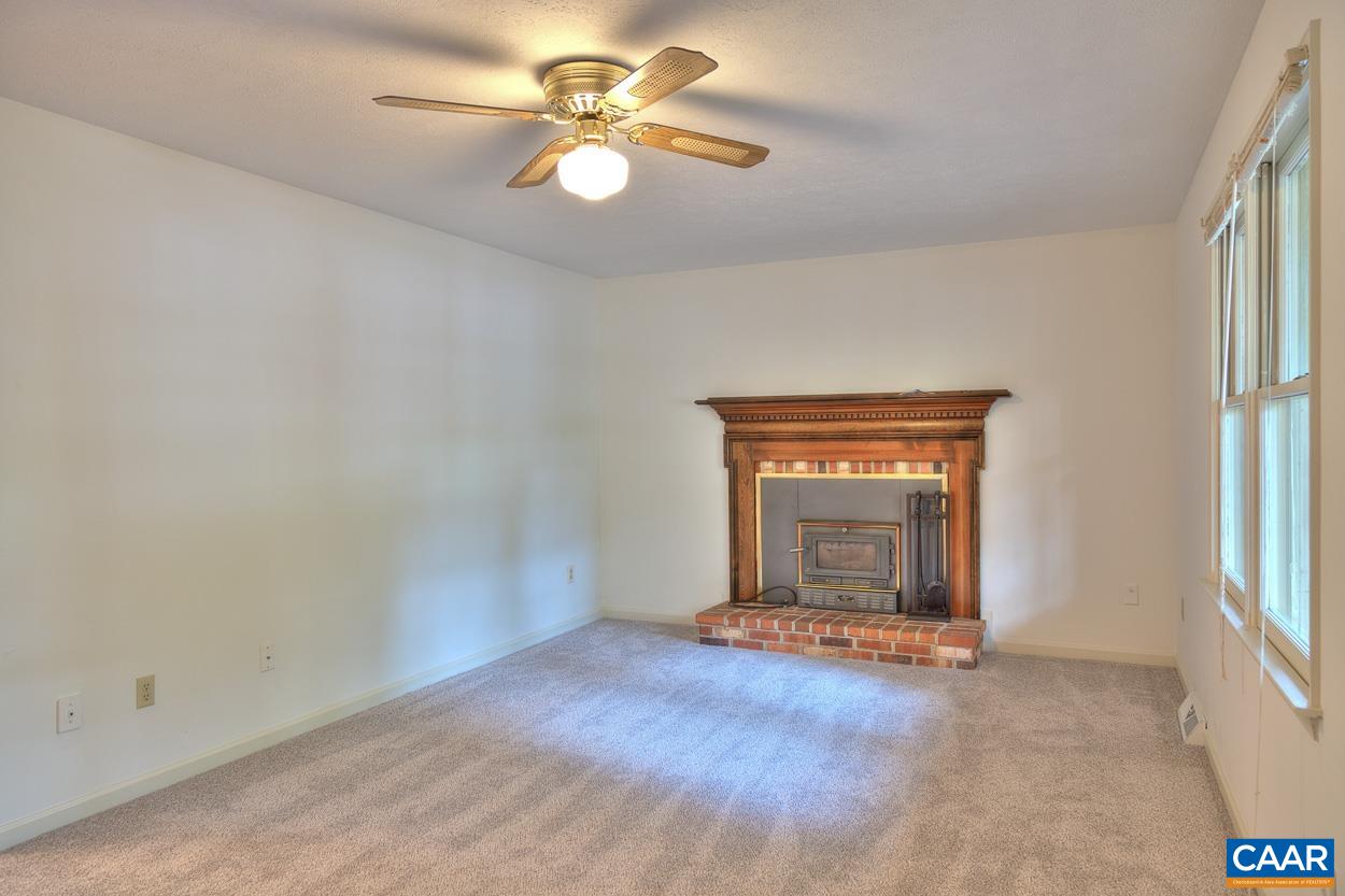 12 Begum Road Palmyra, VA 22963 - Photo 3 of 30 an empty room with a fireplace and windows
