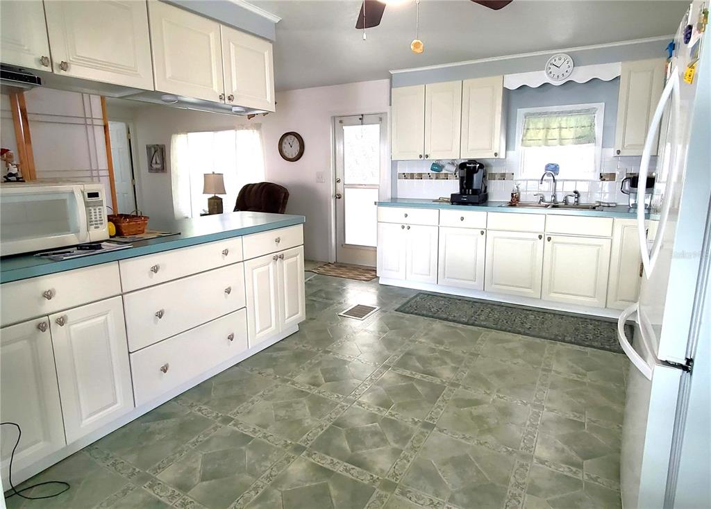 176 West Manatee Loop Punta Gorda, FL 33950 - Photo 11 of 63 a large white kitchen with granite countertop a sink and cabinets