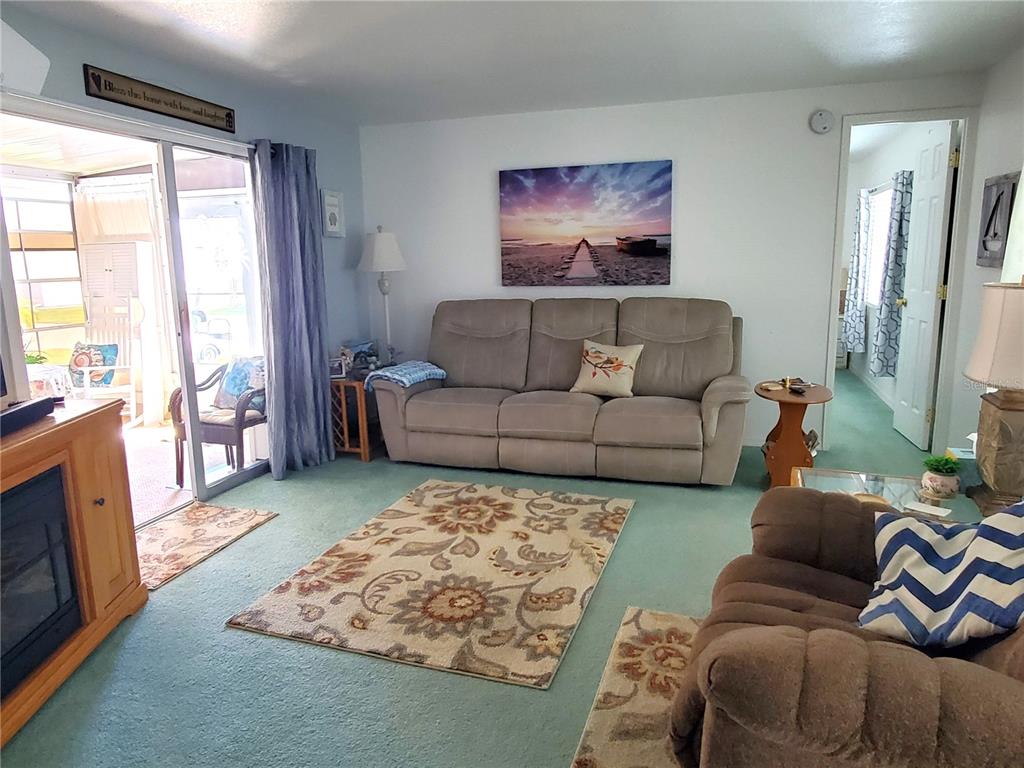 176 West Manatee Loop Punta Gorda, FL 33950 - Photo 15 of 63 a living room with furniture and a flat screen tv