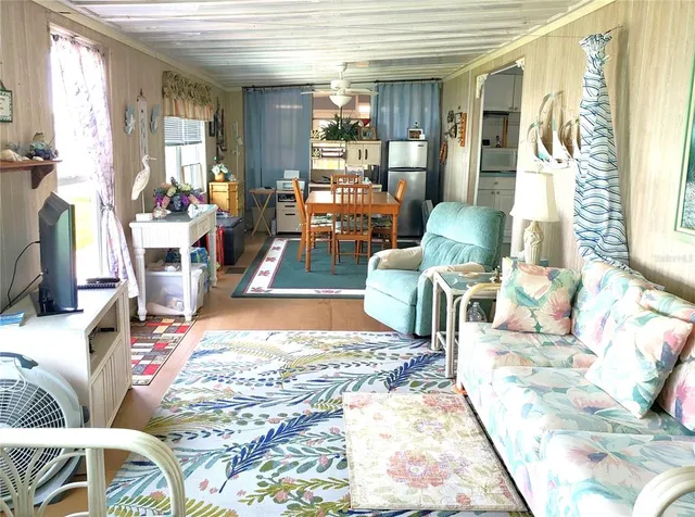a bedroom with a bed and a flat tv screen on dresser