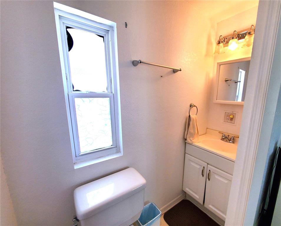 176 West Manatee Loop Punta Gorda, FL 33950 - Photo 28 of 63 a bathroom with a window a sink and a toilet