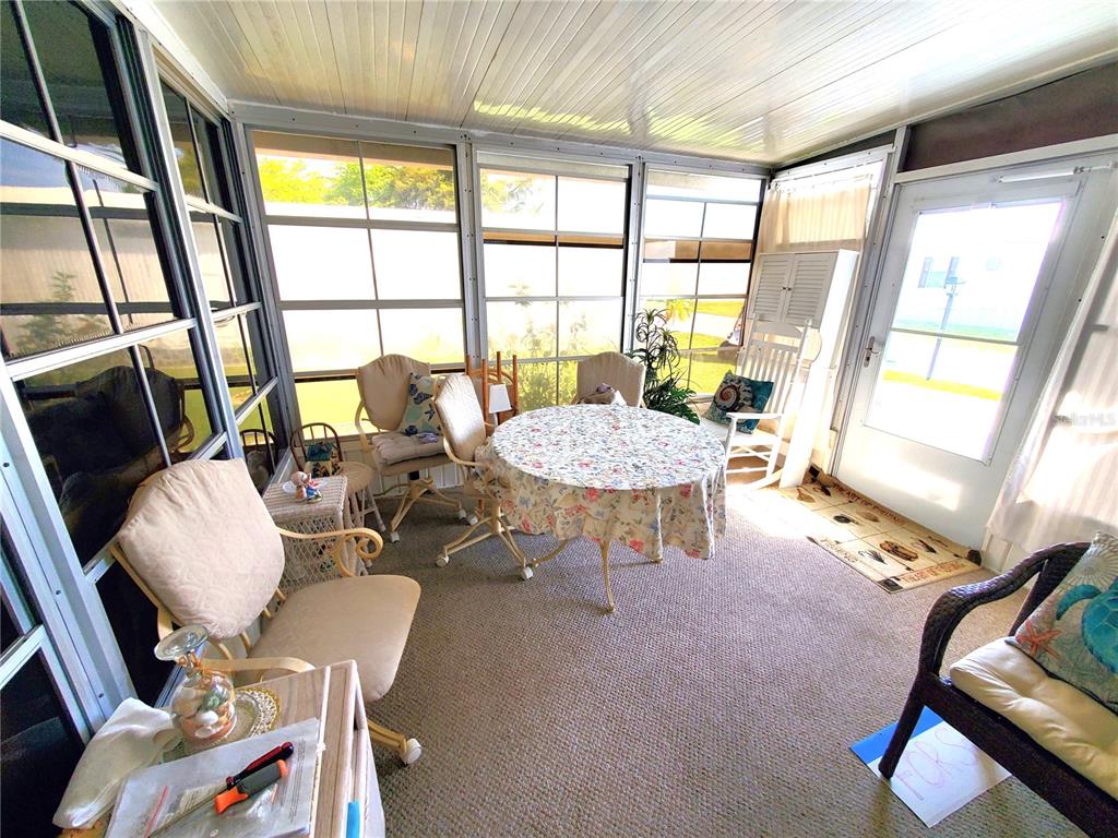 176 West Manatee Loop Punta Gorda, FL 33950 - Photo 35 of 63 a living room with patio furniture and a large window