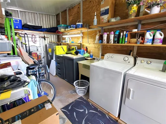 a view of a living room and kitchen space with a flat screen tv