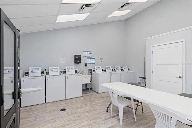 a kitchen with a sink appliances and cabinets