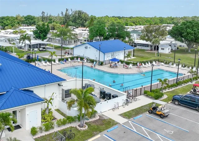 a front view of a house with a yard and potted plants