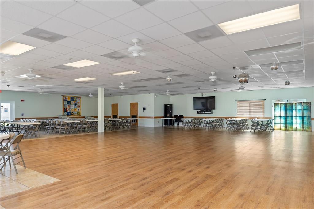 176 West Manatee Loop Punta Gorda, FL 33950 - Photo 45 of 63 a view of a living room and kitchen space with a flat screen tv