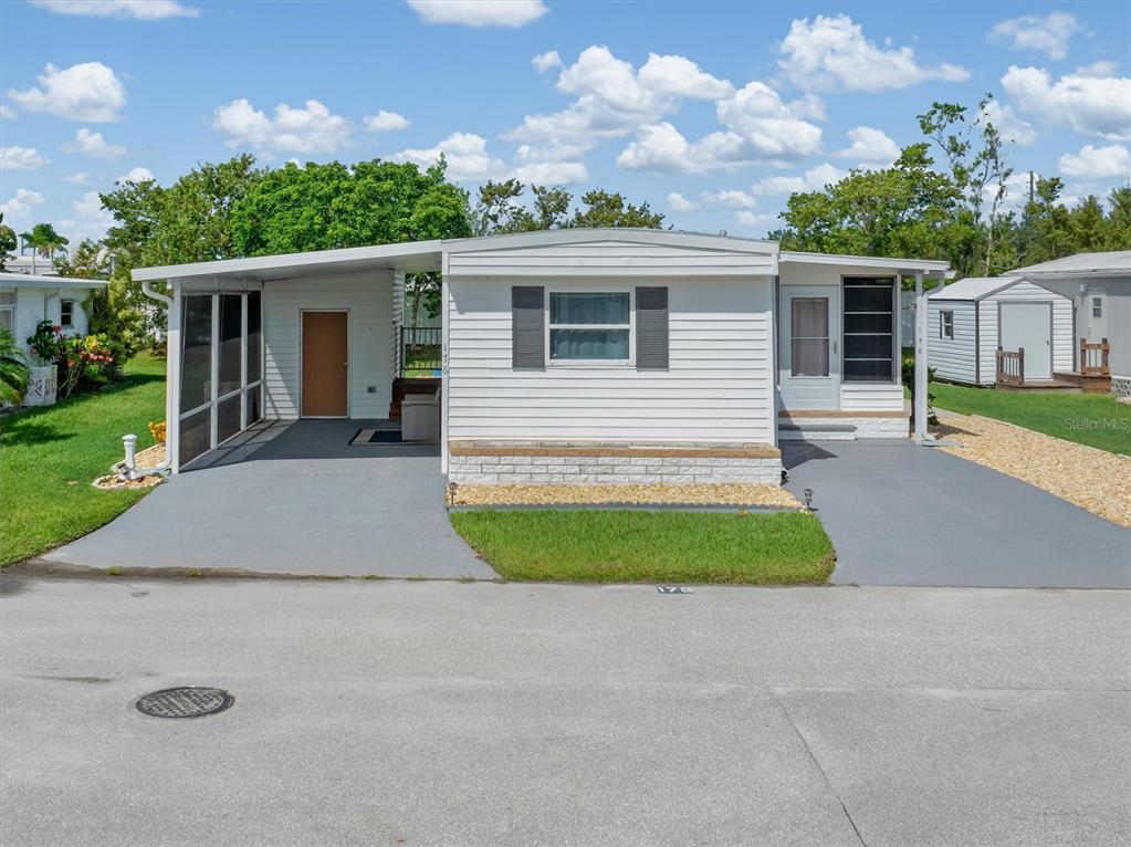 176 West Manatee Loop Punta Gorda, FL 33950 - Photo 48 of 63 front view of house with a yard and potted plants