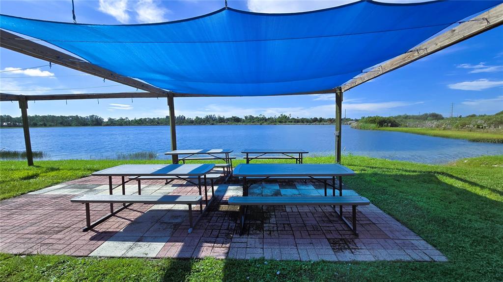 176 West Manatee Loop Punta Gorda, FL 33950 - Photo 5 of 63 a view of a table and chairs on the deck in front of a house