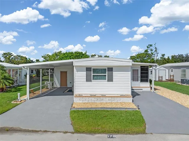 a view of a house with backyard sitting area and garden