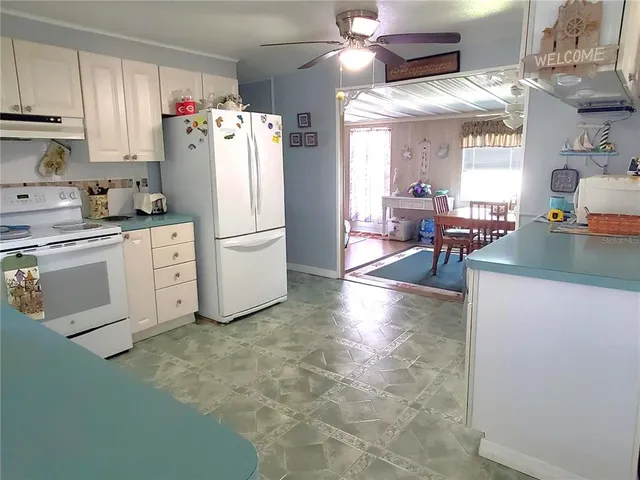 a kitchen with a white cabinets and white appliances