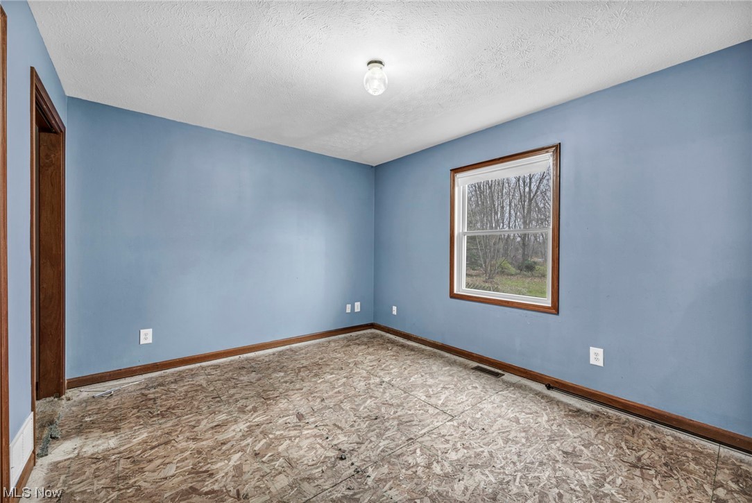 35808 Lorain Road North Ridgeville, OH 44039 - Photo 16 of 35 Tiled empty room featuring a textured ceiling