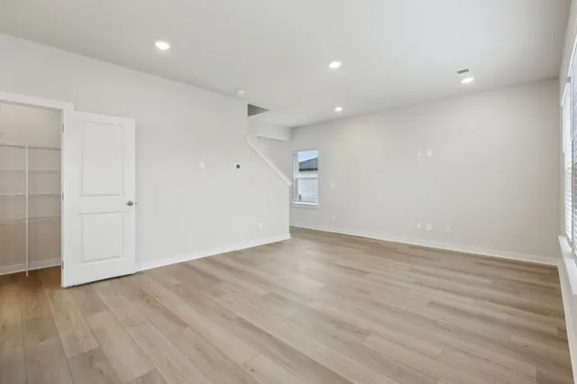 an empty room with wooden floor