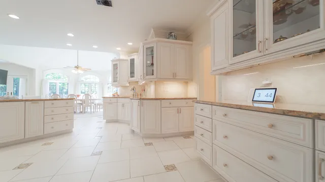 a spacious en suite bathroom with a sink and a mirror