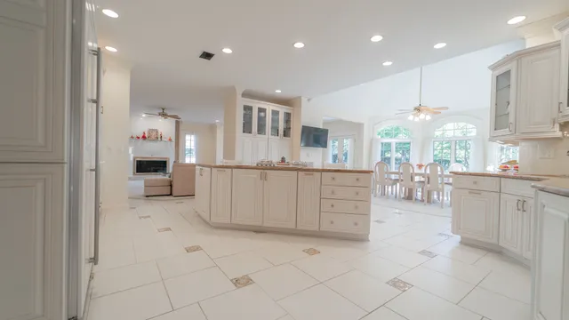 a kitchen with granite countertop white cabinets and a sink