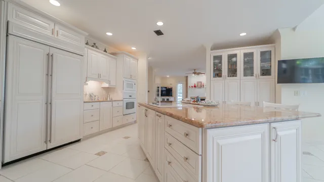 a large kitchen with granite countertop a lot of counter space and a sink