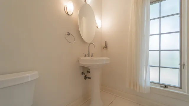 a bathroom with a granite countertop sink mirror and double