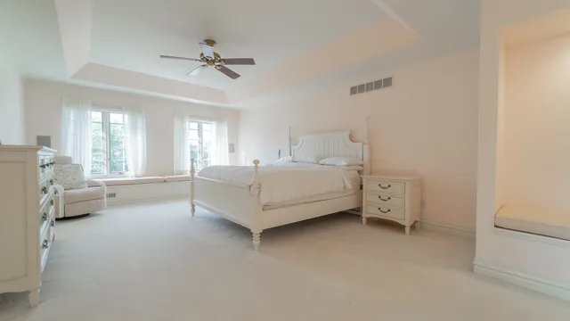a bathroom with a granite countertop toilet sink and mirror