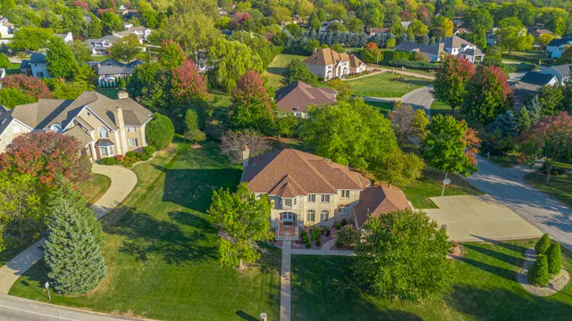 an aerial view of residential houses with outdoor space and street view