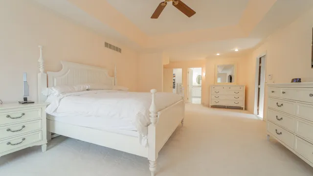 a spacious bedroom with a bed and a window