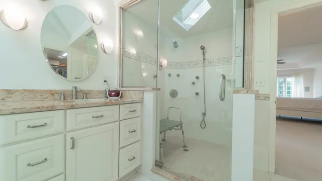 a spacious bedroom with a bed and a chandelier