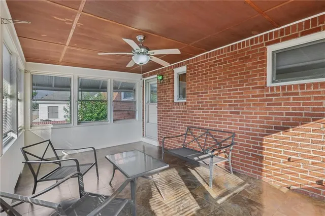 a brick building with a bench and a window